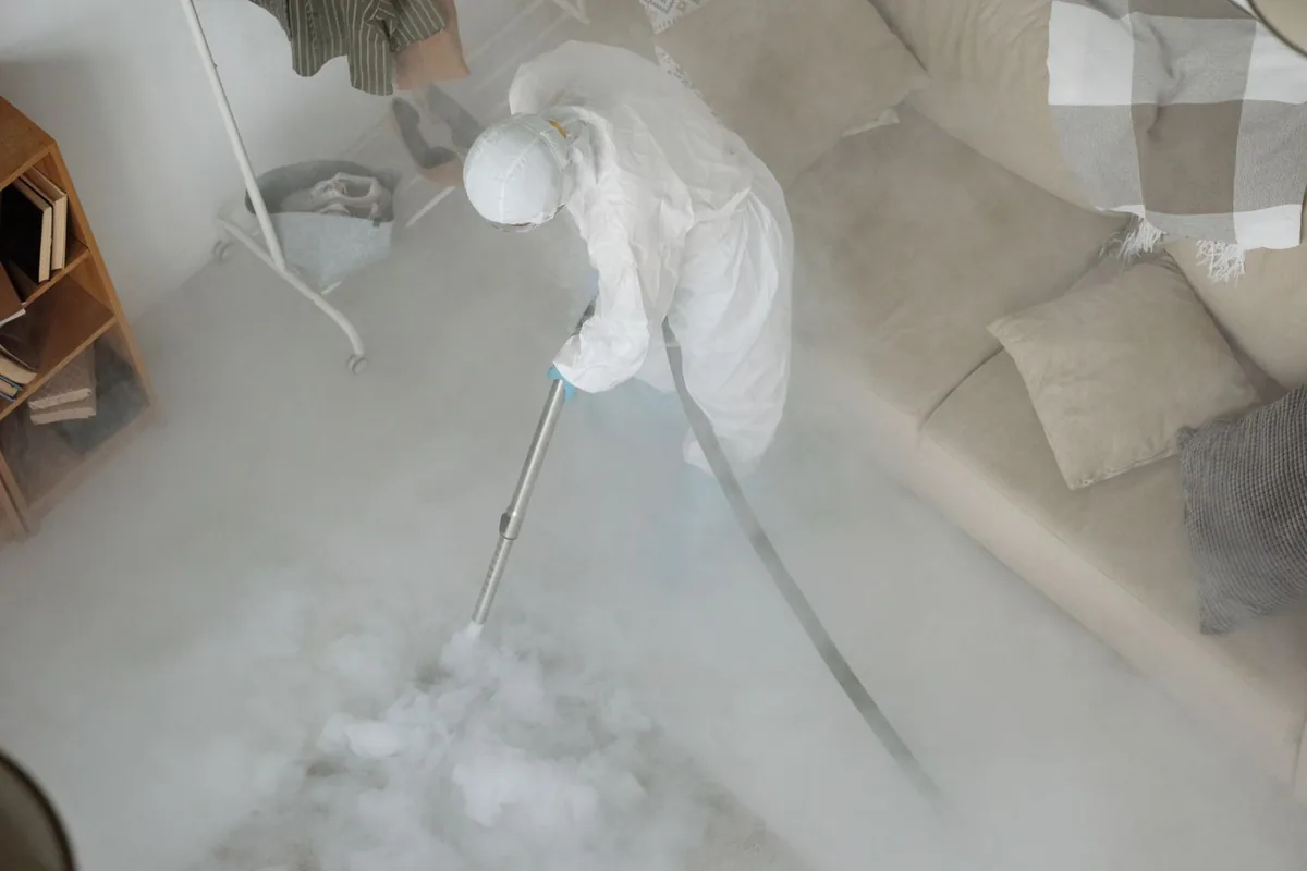Biohazard cleanup technician in protective equipment, Moline Acres, MO
